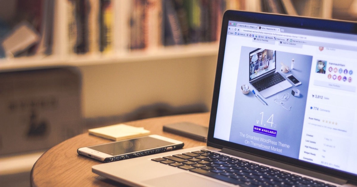 A website shown on a laptop with a smartphone beside it